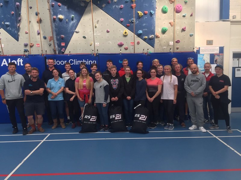 Our squad lined up indoors for a group photograph with three RS21 branded kit bags set out in front of us.